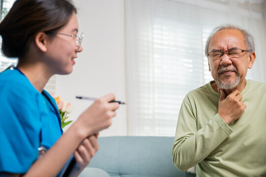 Doctor woman examines lymph nodes on elderly neck to determine if swollen, sore throat, Asian young nurse checking senior old man neck pain in clinic at retirement home, physical therapist
