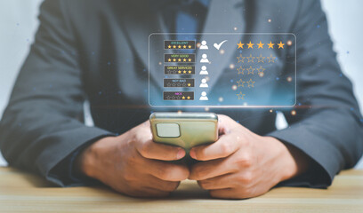 Customer service and Satisfaction concept,Businessman pressing smiley face emoticon on virtual touch screen,happy Smiley face icon to give satisfaction in service. rating very impressed