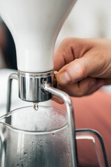 Vertical shot of a process of making an expresso coffee with hands and equipment
