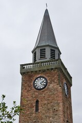 Church tower with clock standing in Highland Scotland