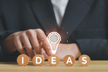 businessman with light bulb, Creative new idea. Innovation, brainstorming, inspiration and solution concepts with icon on wooden cube stack