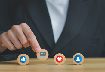 Social media and digital online concept, woman keeping wooden circle stackwith icon. playing social media. Social Distancing ,Working From Home concept