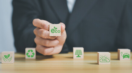 ESG (Environment,Social,Governance) Hand holds wooden cubes,renewable energy, co2 emissions reduction, green production
