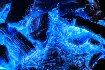 Fiery hot coal in blue glow