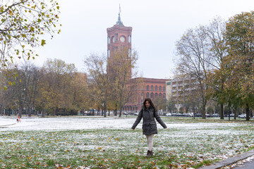 Young female tourist with the Rotes Rathaus in the background and snowy surroundings