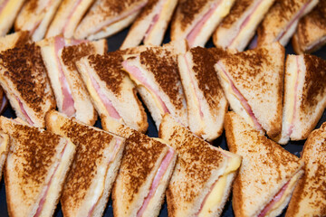 Tray of mini sandwiches for a cocktail.