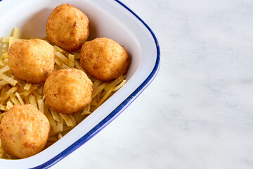 plate with ham croquettes and chips