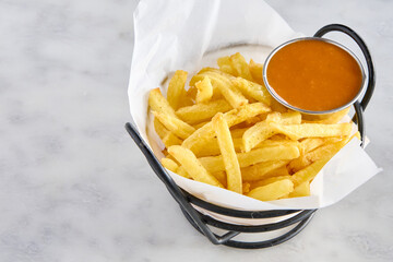 Basket with chips and hot sauce