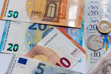 Close up of Euro bank notes and Great Britain Pound sterling notes and coins.