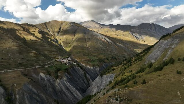 remote village in the french alps aerial back traveling summer day with clouds la grave les terrasses