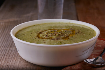 Broccoli soup garnished with cheese,pepper and a splash of olive oil.
