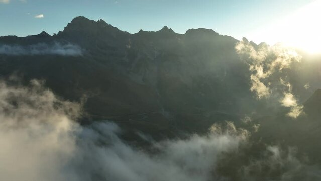 Epic clouds mist over the mountains french alps sunrise aerial shot 