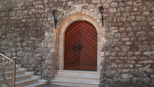 The concept of preserving the ancient heritage. Doors to a medieval stone fortress.