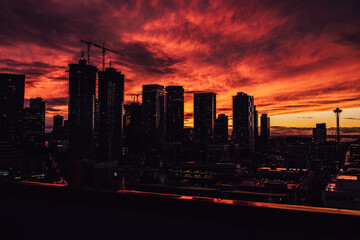 dramatic red, orange, dark winter sunset with Seattle skyline 