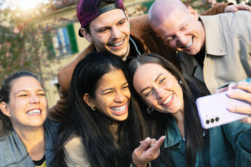 happy group of multiracial friends having fun watching smartphone outdoors on city , Young trendy student laughing and smiling at campus college-Friendship and technology Concept- youth culture