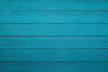 Pine wood slats surface painted cold green, textured background.