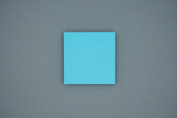 Blue blank sticky notes on gray background. Copy space for text, top view