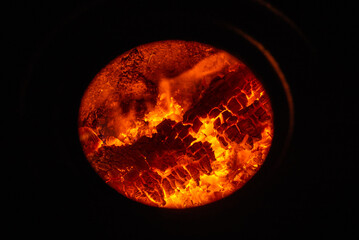 wood burns in the fireplace Heat energy heap closely, red and yellow, thermal energy at the fuel point during the night / lights on a black background flames Campfire circle. stove