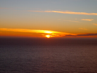 Sunset through the clouds over the Pacific Ocean