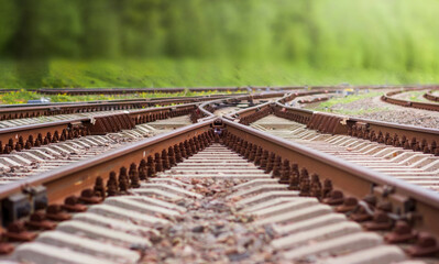 a fork in the railway tracks with a turn on a summer day. selective focus on rail crossing