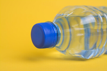 Plastic water bottle on yellow