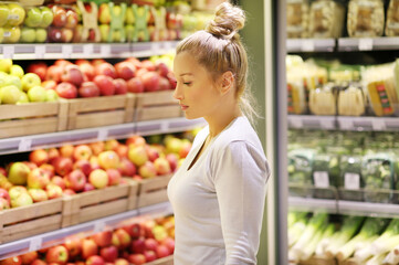 Woman buying fruits and vegetables at the market