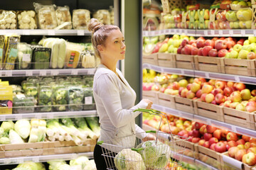 Woman buying fruits and vegetables at the market