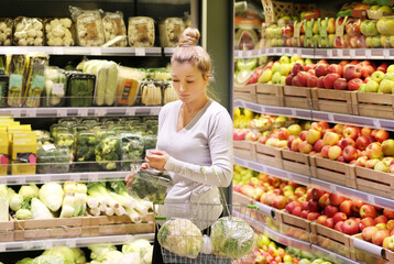 Woman buying fruits and vegetables at the market