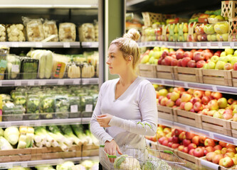 Woman buying fruits and vegetables at the market