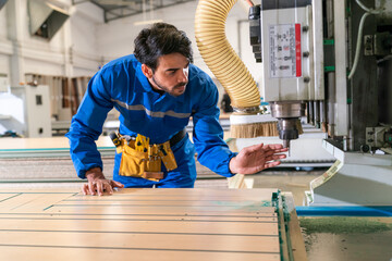 Carpenter making furniture in workshop