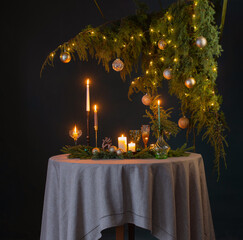 green and golden christmas decor on table on dark background