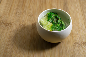 Mojito lime and mint in white mug isolated on wooden background