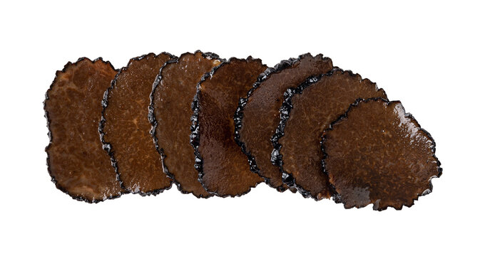 Row of black truffle slices in oil cutout. Truffle carpaccio isolated on a white background. Canned Tuber melanosporum slices macro. Delicacy mushroom for gourmet ingredient taste.