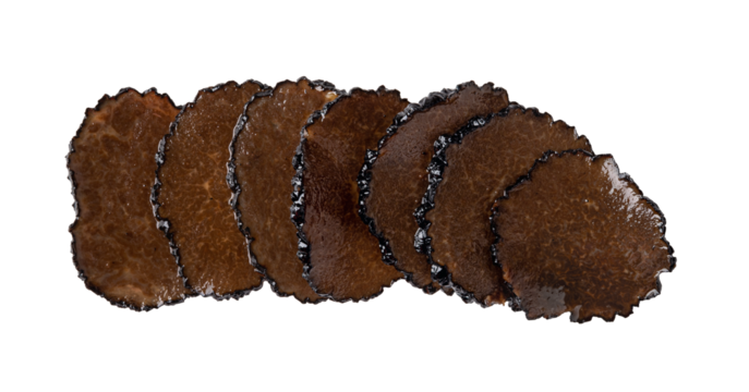 Row of black truffle slices in oil cutout. Truffle carpaccio isolated on a white background. Canned Tuber melanosporum slices macro. Delicacy mushroom for gourmet ingredient taste.