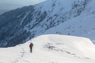 Fototapeta na wymiar Skitour in a big snowy mountains, an adrenaline outdoor adventures