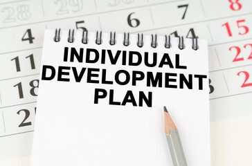 On the calendar is a notebook with the inscription - INDIVIDUAL DEVELOPMENT PLAN