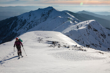 Fototapeta na wymiar Skitour in a big snowy mountains, an adrenaline outdoor adventures