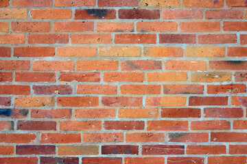 Part of red bricks wall with concrete joints as background front view close up horizontal photo