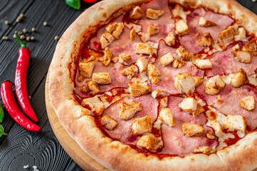 Tasty and big pizza with different types of meat