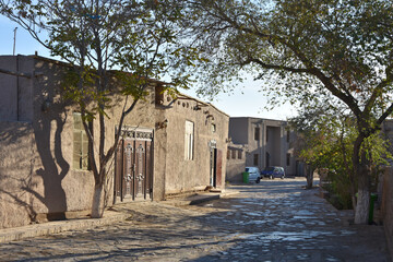 Old streets in oriental style of Khiva city in Uzbekistan with trees and houses