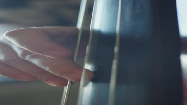 Vertical shot of hands of unrecognizable jazzman playing double bass music