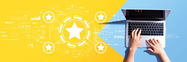 Rating star concept with person using a laptop computer