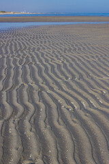 Beautiful seascape. Low tide in Porto Caleri, Rosolina, Italy. Vertical image.