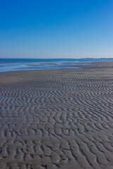 Fototapeta na wymiar Beautiful seascape. Low tide in Porto Caleri, Rosolina, Italy. Vertical image.