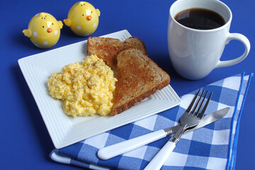Scrambled eggs and multi-grain toast with coffee for breakfast.