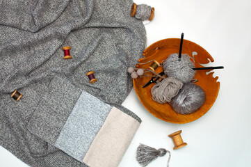 Grey fabric samples and wooden knitting bowl