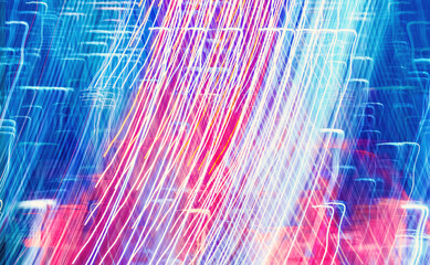 Abstract blurred bokeh neon light trails city night background