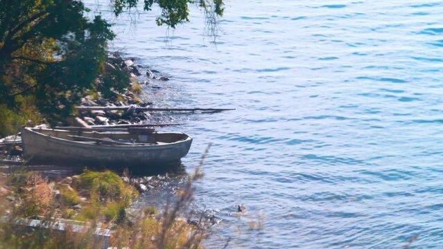 Wooden rowing cockboat (old vessel) on the shore of Lake Baikal. Siberia