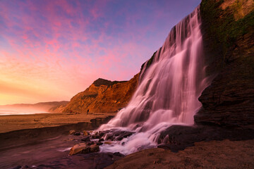 Colorful sunset light on Alamere Falls, Point Reyes National Seashore, California.