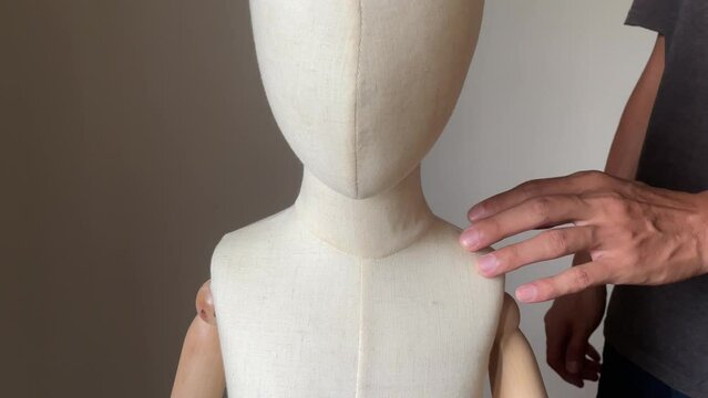 Creepy male hand touching and groping child mannequin body. Child abuse concept. Young children victim of domestic violence.